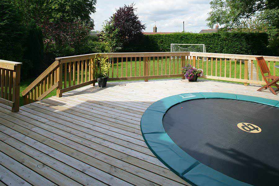 Trampoline incorporated within timber decking area