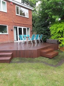Raised Trex deck attached to house with dining table and chairs