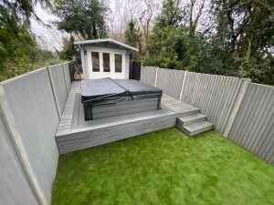 Raised grey Trex deck outside garden summer house