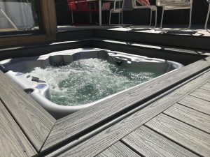 Grey Trex deck with integrated sunken hot tub