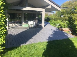 Large grey Trex deck attached to modern house