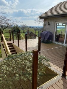 Brown Trex deck used on balcony area with clear glass railing