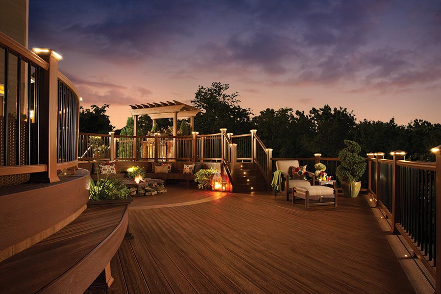Trex deck living area at dusk, showing the range Trex outdoor lighting