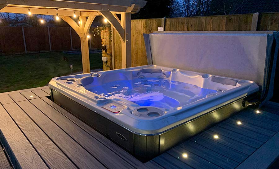 Trex deck surrounding a hot tub with lighting