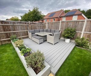 Corner Trex deck in grey with seating and planters