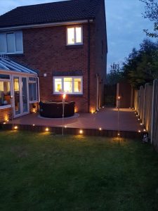 Brown Trex deck with spotlights shown at night
