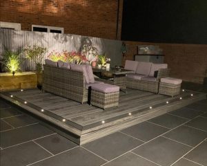 Grey Trex deck at night with integrated spotlights