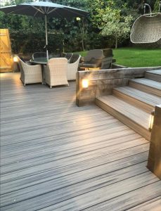 Close-up of Grey Trex deck outside house with outdoor light