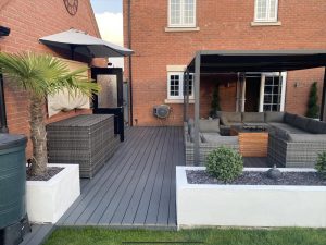 Large Trex deck in grey with seating area and pergola