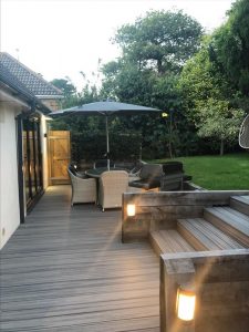 Grey Trex deck outside house with outdoor light